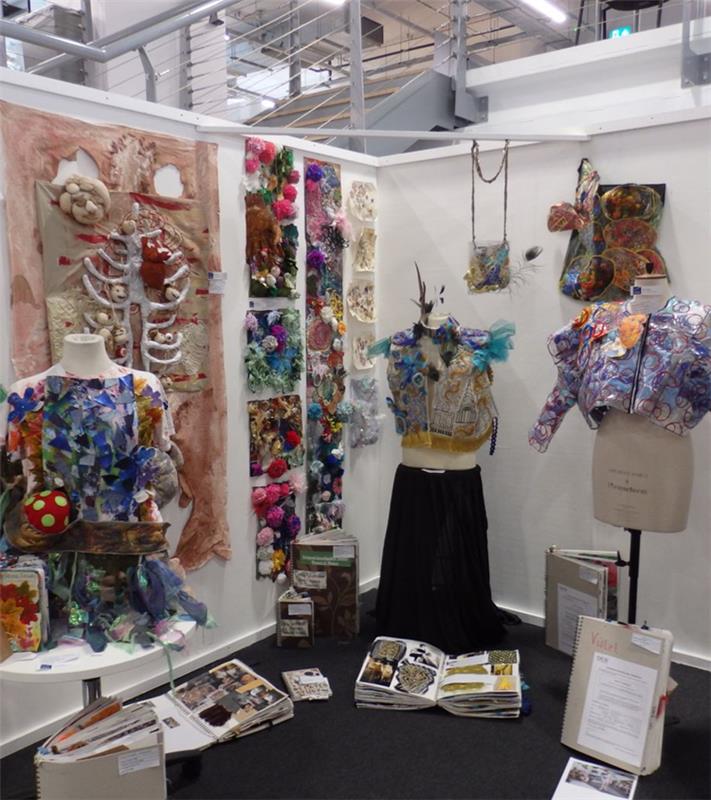 Students' textile work displayed on mannequins and tables ready for moderation